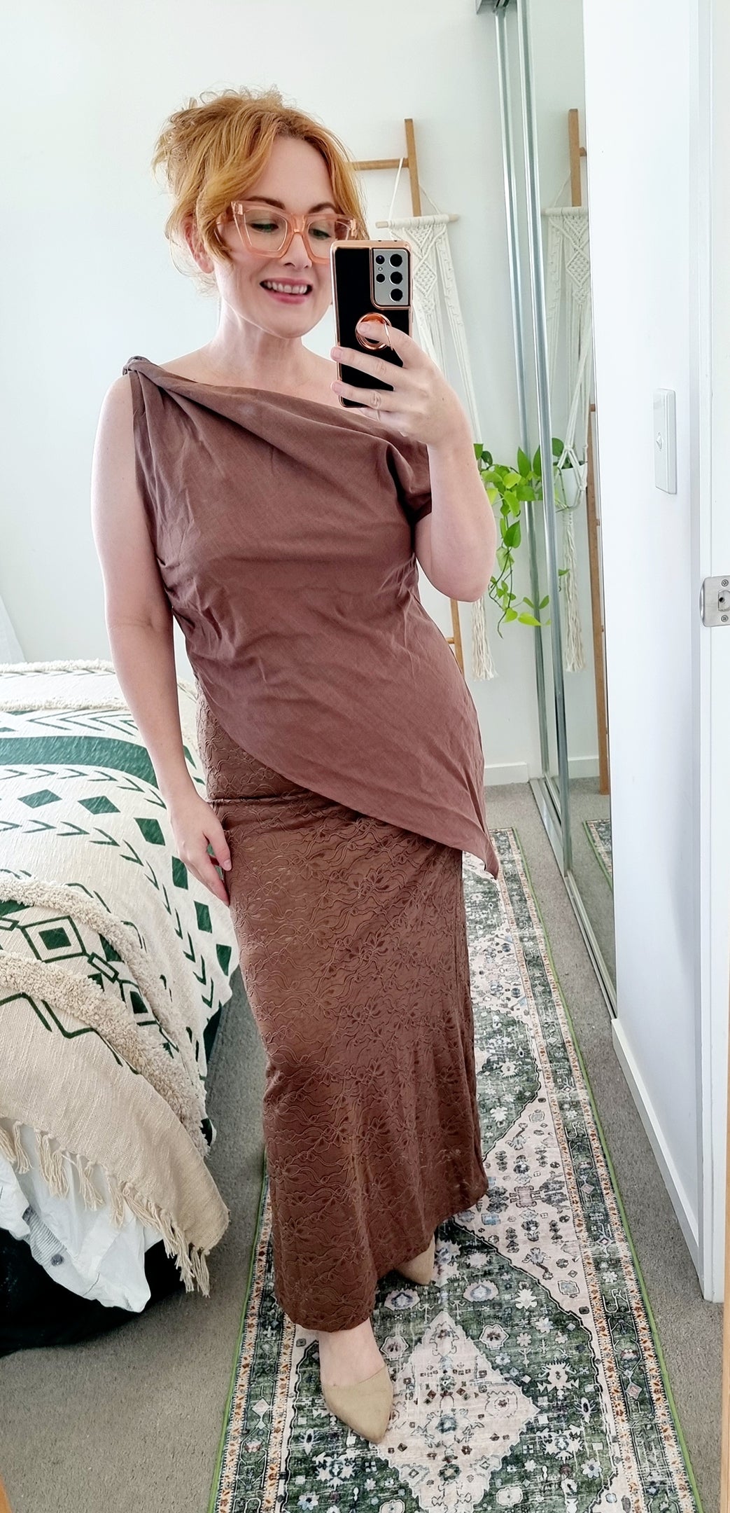 Tegan wearing the Terra Set in Chocolate by By Frankie. The one-shoulder linen top is paired with a coordinating brown lace maxi skirt. Tegan is an AU size 10 and wears the Medium.