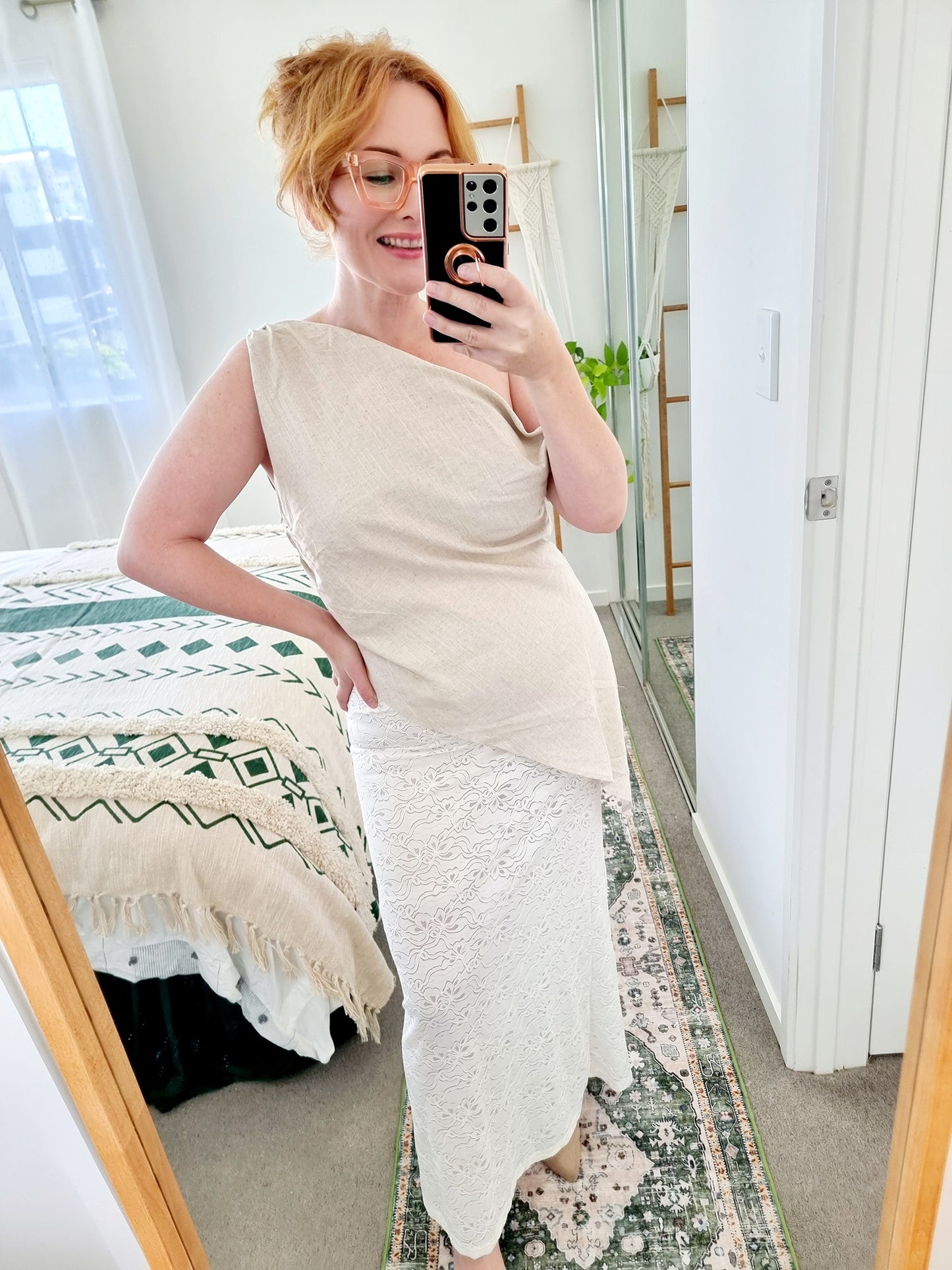 Tegan wearing the Terra Set in Oatmeal by By Frankie. Features an asymmetrical linen top and sheer embroidered lace maxi skirt. Tegan is an AU size 10 and wears the Medium.