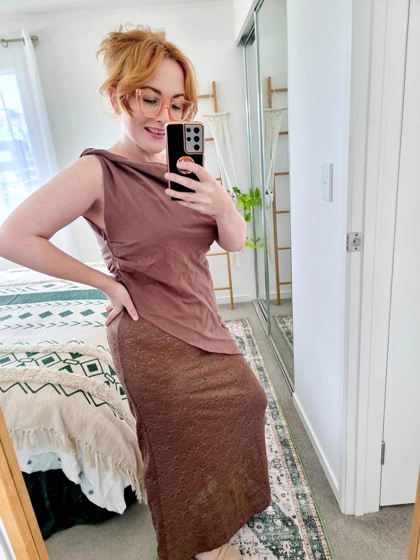 Tegan wearing the Terra Set in Chocolate by By Frankie. The one-shoulder linen top is paired with a coordinating brown lace maxi skirt. Tegan is an AU size 10 and wears the Medium.