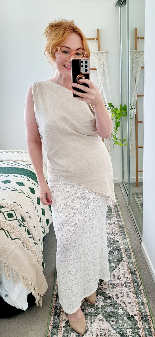 Tegan wearing the Terra Set in Oatmeal by By Frankie. Features an asymmetrical linen top and sheer embroidered lace maxi skirt. Tegan is an AU size 10 and wears the Medium.