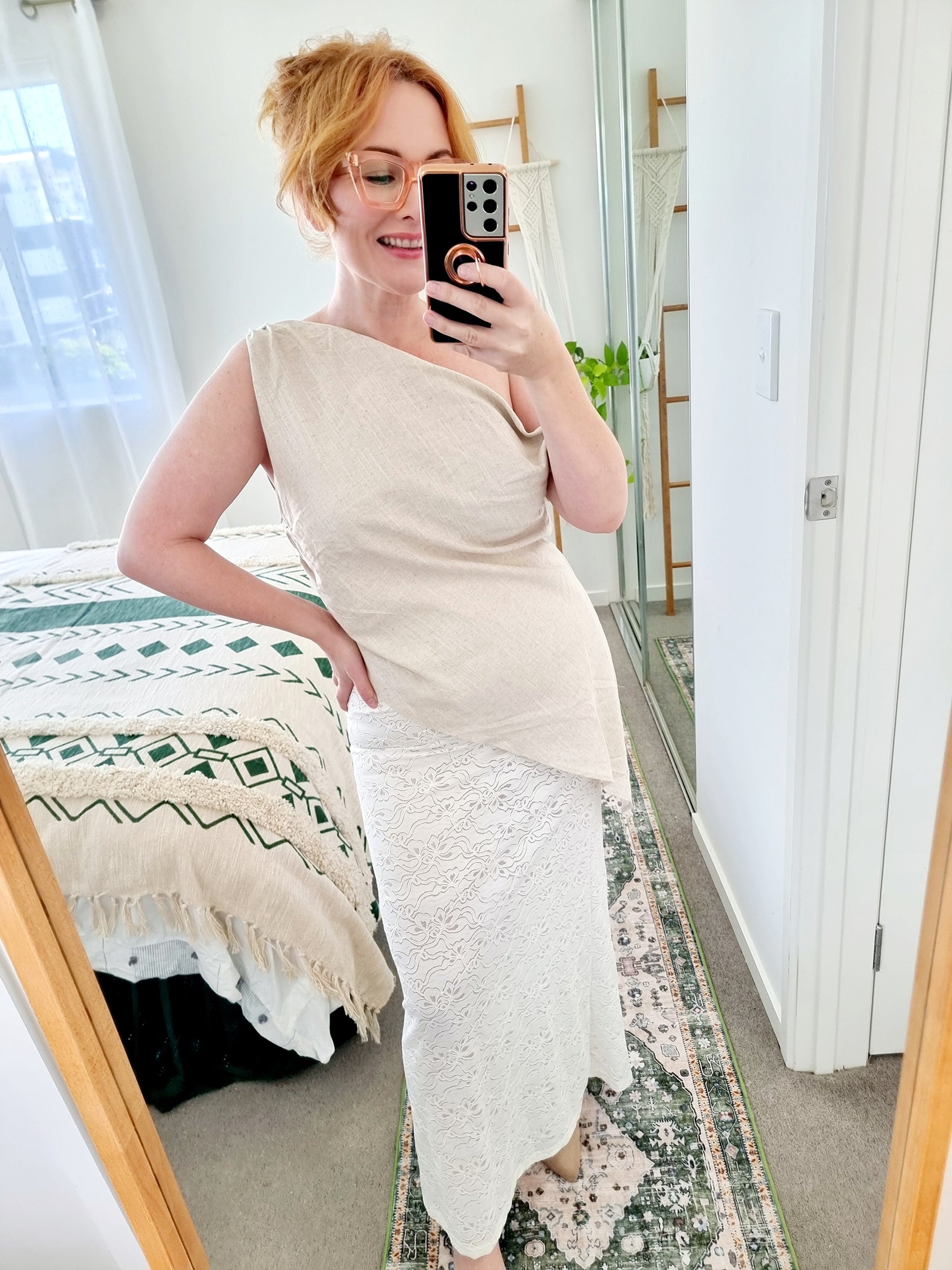 Tegan wearing the Terra Set in Oatmeal by By Frankie. Features an asymmetrical linen top and sheer embroidered lace maxi skirt. Tegan is an AU size 10 and wears the Medium.