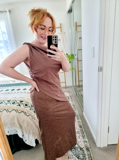 Tegan wearing the Terra Set in Chocolate by By Frankie. The one-shoulder linen top is paired with a coordinating brown lace maxi skirt. Tegan is an AU size 10 and wears the Medium.