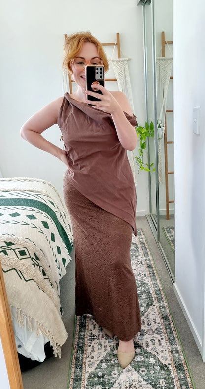 Tegan wearing the Terra Set in Chocolate by By Frankie. The one-shoulder linen top is paired with a coordinating brown lace maxi skirt. Tegan is an AU size 10 and wears the Medium.